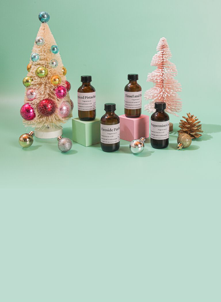 fragrance bottles with festive trees and ornaments