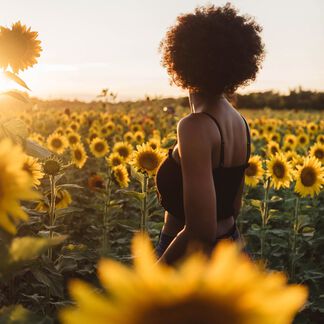 A woman in a field of sunflowers