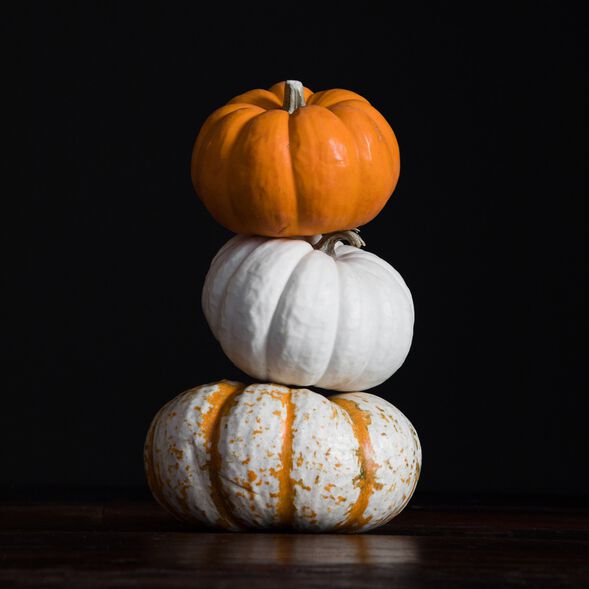 Three small pumpkins stacked