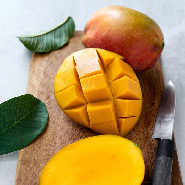Sliced mangos on a cutting board