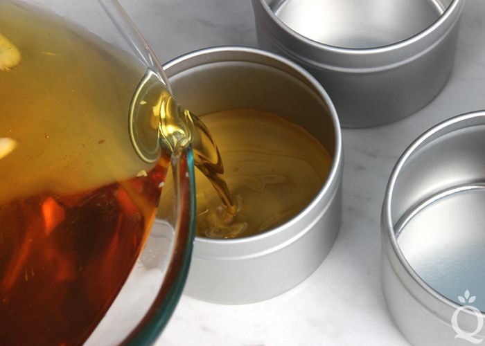 Pouring
                melted wax into a tin