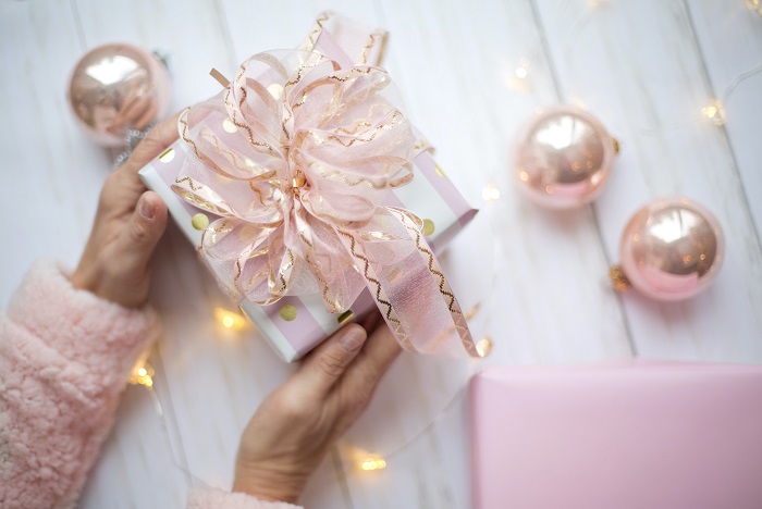Two hands holding a wrapped gift Two hands holding a wrapped gift
