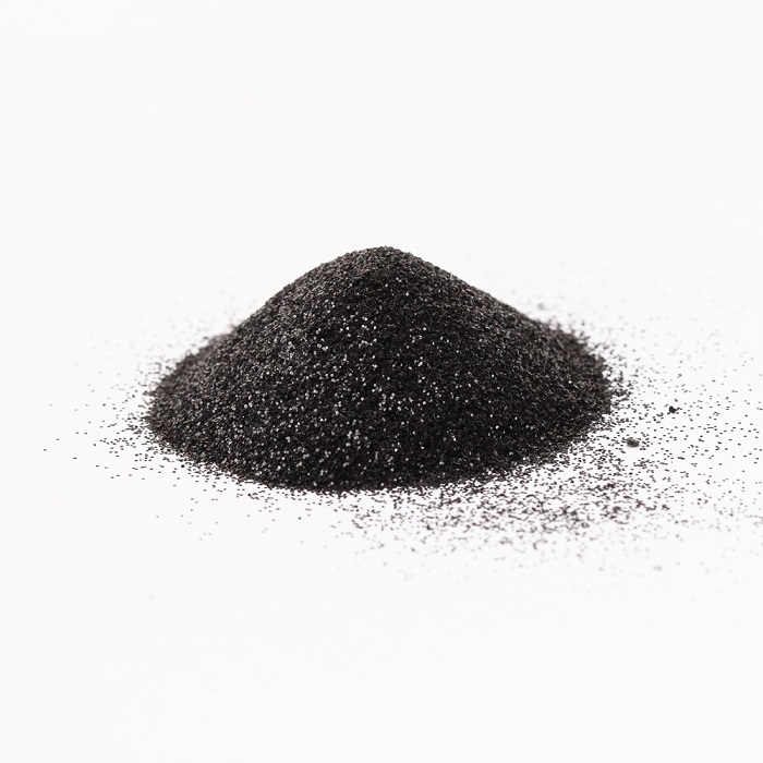 a
                small pile of black glitter against a white background