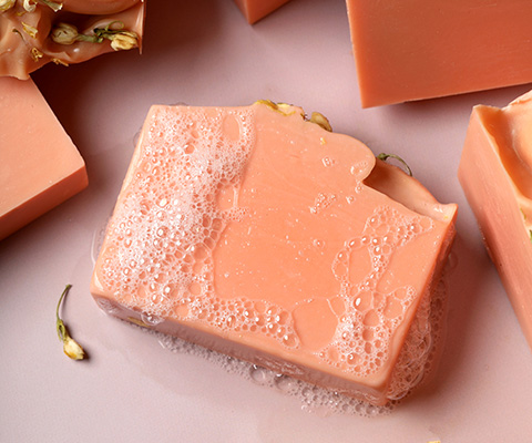 peach colored bar of cold process soap
