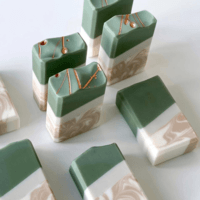 green, white, and gold soap bars