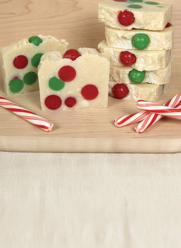 white soaps with green and red embedded balls