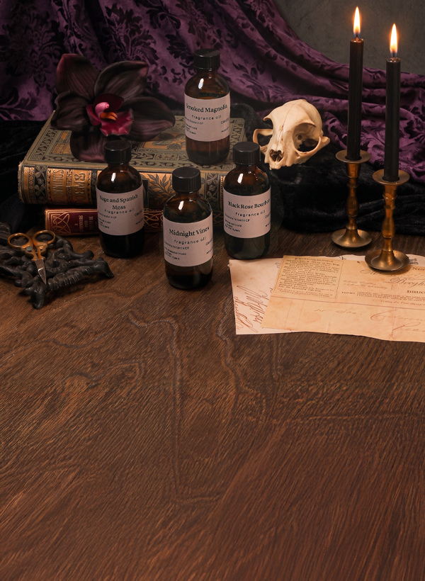 fragrance bottles with candles and a skull