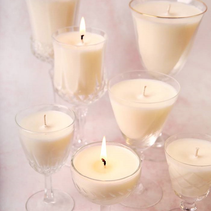 Goblet candles Candles in clear stem glasses, some lit