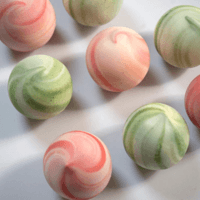 green and red swirled soap balls