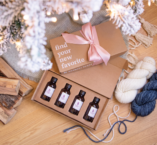 fragrance collection surrounded by cozy winter items