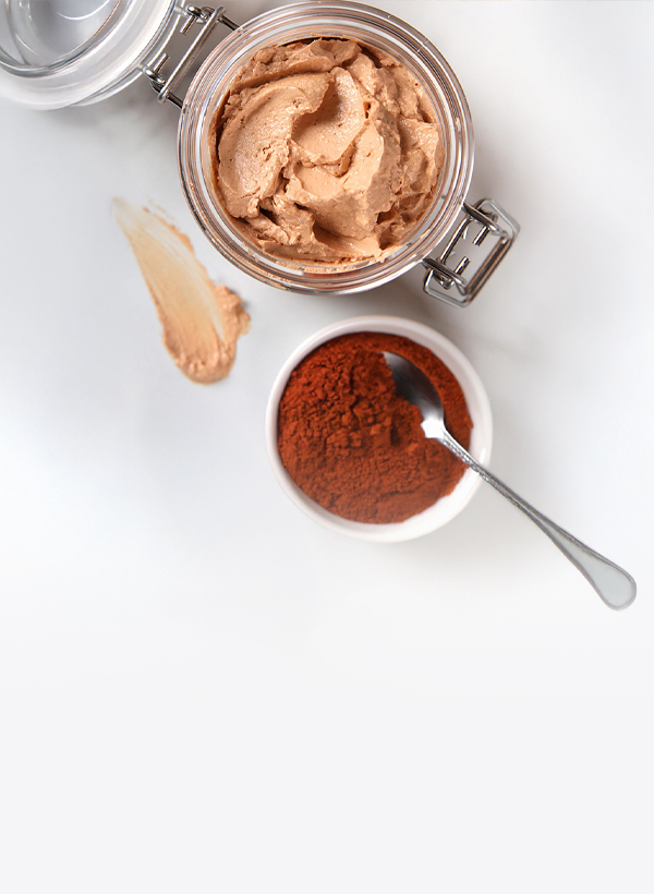 open container of face mask and a small dish of pigment